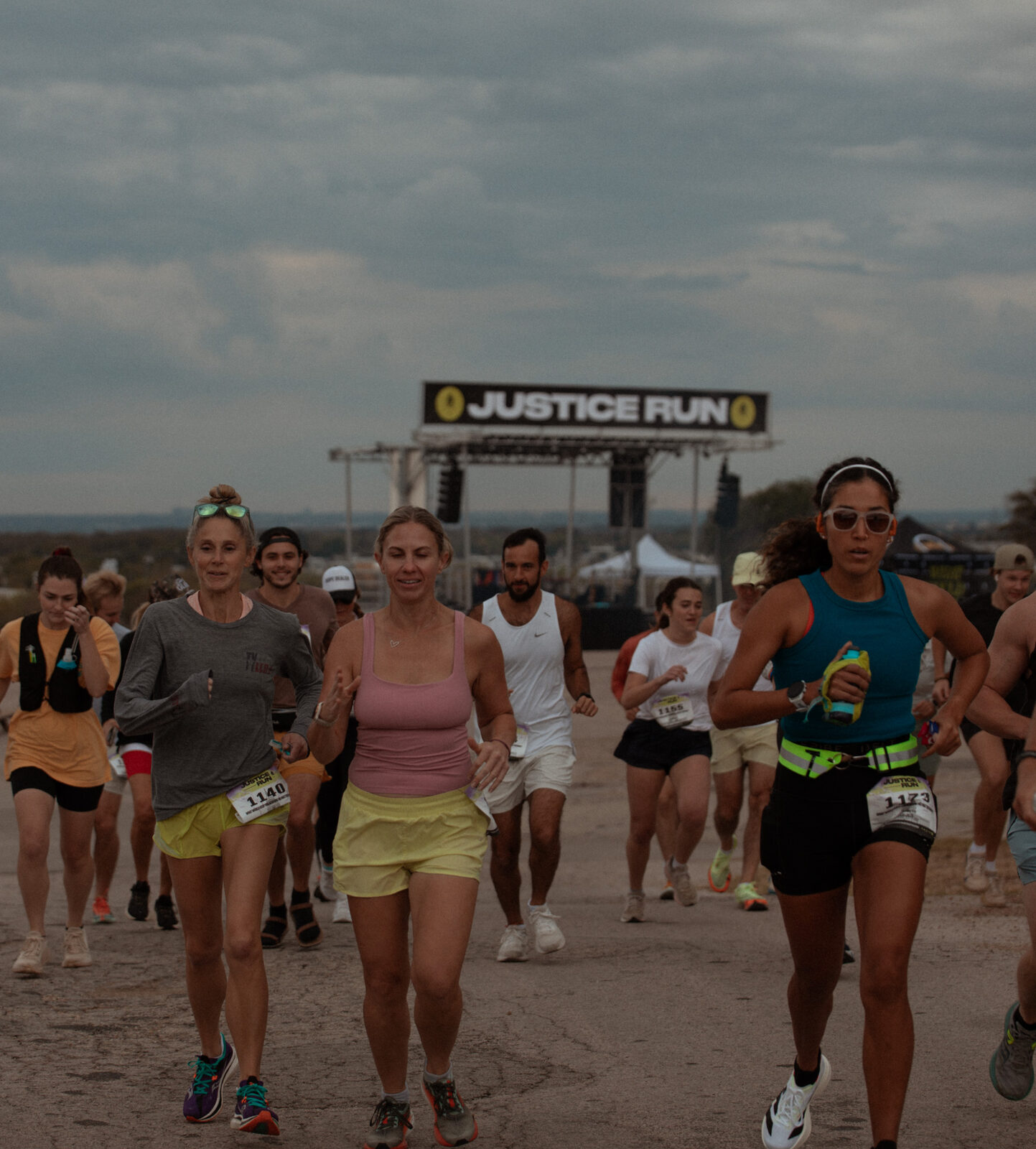 Runners under the Justice Run start arch